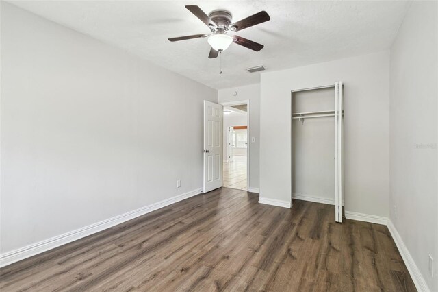 5010 8th Ave N, Saint Petersburg, FL 33710 - unfurnished bedroom with wood finished floors, baseboards, a closet, and a ceiling fan