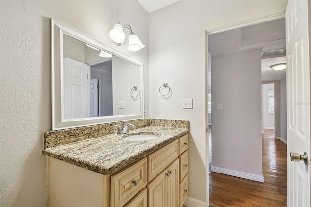 5010 8th Ave N, Saint Petersburg, FL 33710 - bathroom with vanity, wood finished floors, and baseboards
