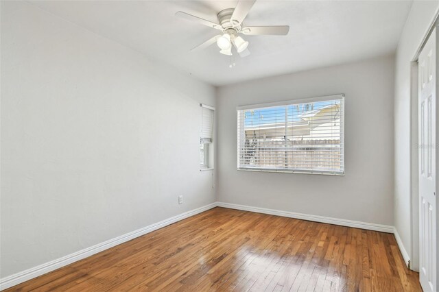 5010 8th Ave N, Saint Petersburg, FL 33710 - spare room with hardwood / wood-style flooring, baseboards, and a ceiling fan