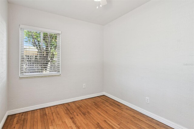 5010 8th Ave N, Saint Petersburg, FL 33710 - unfurnished room with baseboards, wood-type flooring, and a ceiling fan