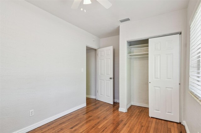 5010 8th Ave N, Saint Petersburg, FL 33710 - unfurnished bedroom with wood finished floors, baseboards, a closet, and ceiling fan