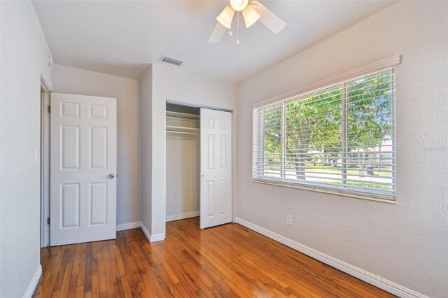 5010 8th Ave N, Saint Petersburg, FL 33710 - unfurnished bedroom with hardwood / wood-style flooring, baseboards, and a closet
