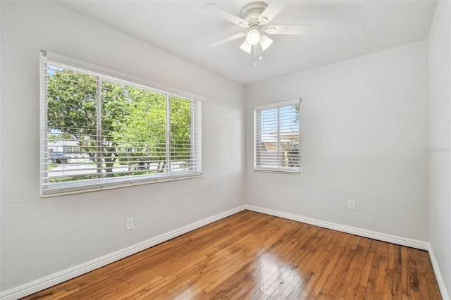 5010 8th Ave N, Saint Petersburg, FL 33710 - unfurnished room featuring baseboards, hardwood / wood-style floors, and a ceiling fan