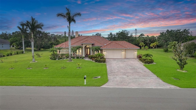6120 9th Avenue Cir NE, Bradenton, FL 34212 - mediterranean / spanish home with a garage, decorative driveway, a chimney, a front lawn, and a tile roof