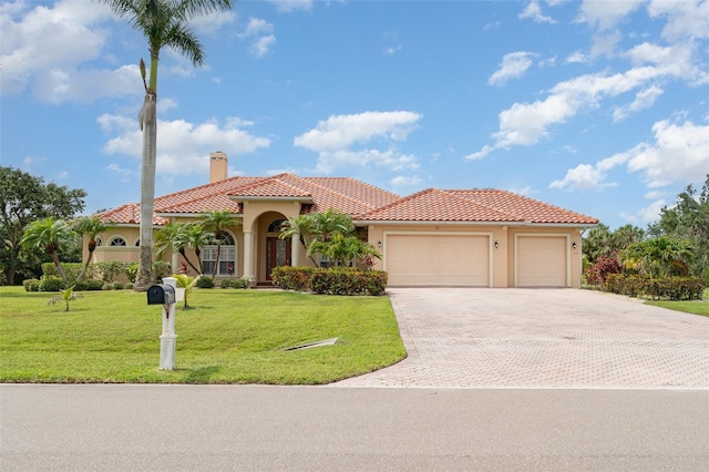 6120 9th Avenue Cir NE, Bradenton, FL 34212 - mediterranean / spanish house with a tile roof, stucco siding, a garage, and a chimney