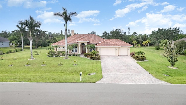 6120 9th Avenue Cir NE, Bradenton, FL 34212 - mediterranean / spanish home with a garage, decorative driveway, stucco siding, a tiled roof, and a front lawn