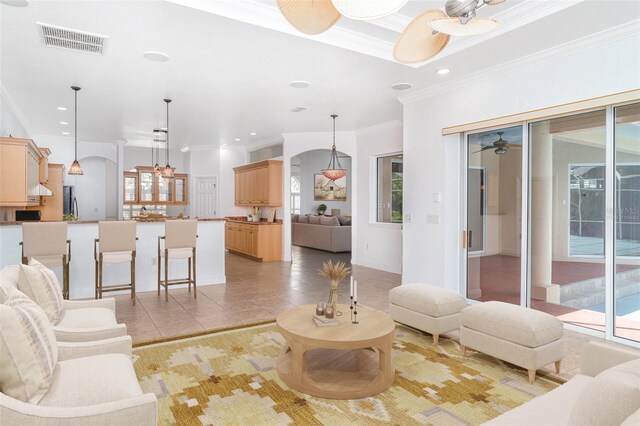 6120 9th Avenue Cir NE, Bradenton, FL 34212 - living room with ornamental molding, arched walkways, recessed lighting, light tile patterned flooring, and ceiling fan