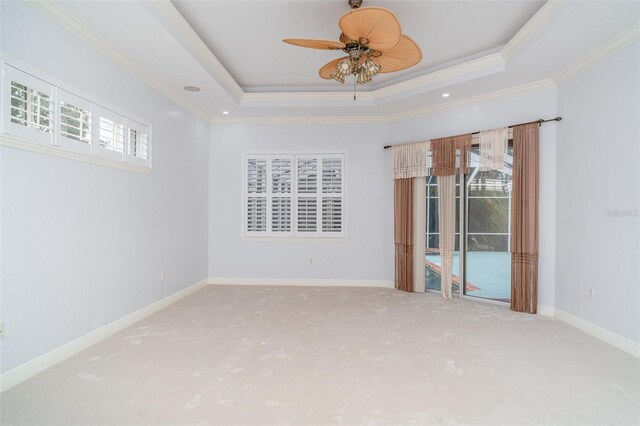 6120 9th Avenue Cir NE, Bradenton, FL 34212 - carpeted empty room with healthy amount of natural light, a tray ceiling, ornamental molding, a ceiling fan, and baseboards