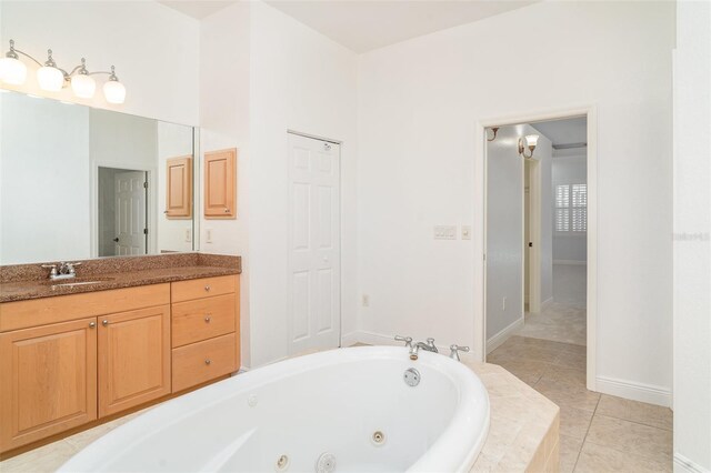 6120 9th Avenue Cir NE, Bradenton, FL 34212 - full bathroom with a whirlpool tub, vanity, tile patterned flooring, and baseboards