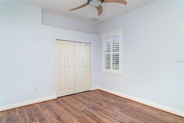 6120 9th Avenue Cir NE, Bradenton, FL 34212 - unfurnished bedroom with wood finished floors, baseboards, a closet, and a ceiling fan