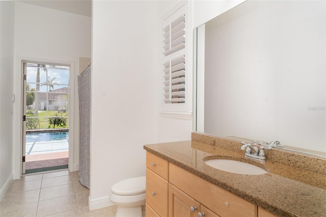 6120 9th Avenue Cir NE, Bradenton, FL 34212 - full bath featuring toilet, vanity, baseboards, and tile patterned floors