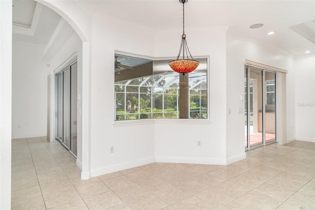 6120 9th Avenue Cir NE, Bradenton, FL 34212 - unfurnished dining area featuring crown molding, arched walkways, tile patterned flooring, baseboards, and a ceiling fan