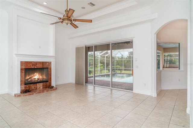 6120 9th Avenue Cir NE, Bradenton, FL 34212 - unfurnished living room with arched walkways, light tile patterned flooring, ornamental molding, and plenty of natural light
