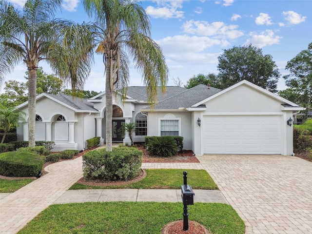 21215 Preservation Dr, Land O Lakes, FL 34639 - single story home with stucco siding, a garage, decorative driveway, and a front yard