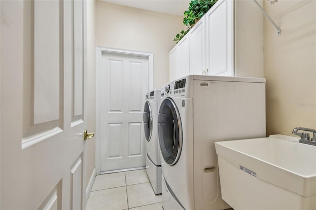 21215 Preservation Dr, Land O Lakes, FL 34639 - laundry room with washing machine and dryer, cabinet space, and light tile patterned floors
