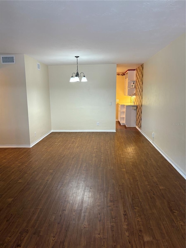 4152 56th Way N Unit 513, Kenneth City, FL 33709 - empty room featuring a chandelier and dark wood-type flooring