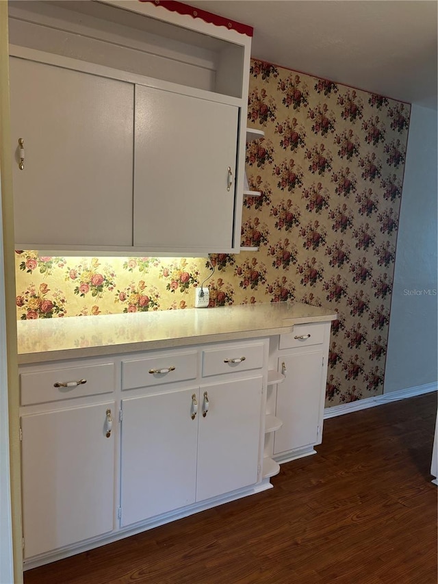 4152 56th Way N Unit 513, Kenneth City, FL 33709 - kitchen with open shelves, wallpapered walls, dark wood-type flooring, white cabinets, and light countertops