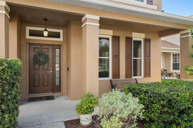460 Tess Ct, Orlando, FL 32824 - doorway to property featuring stucco siding and a porch