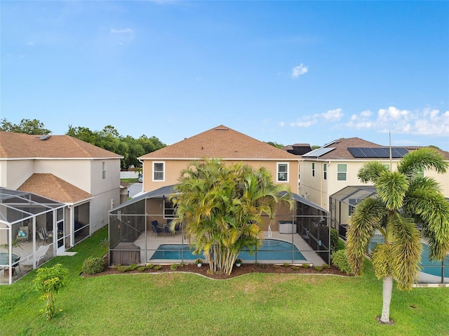 460 Tess Ct, Orlando, FL 32824 - rear view of house with a lanai, a patio area, a yard, and stucco siding