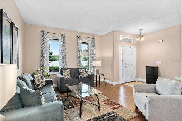 460 Tess Ct, Orlando, FL 32824 - living room with wood finished floors, a chandelier, and baseboards