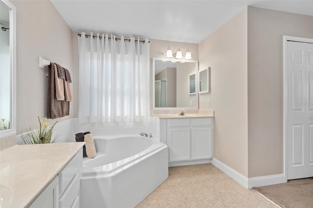 460 Tess Ct, Orlando, FL 32824 - bathroom featuring a garden tub, a stall shower, vanity, baseboards, and tile patterned flooring