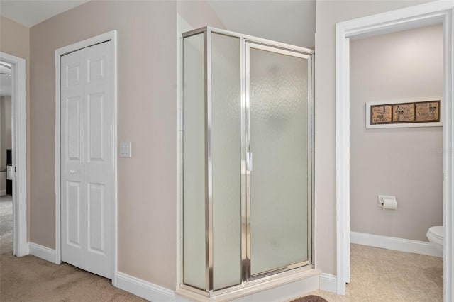 460 Tess Ct, Orlando, FL 32824 - bathroom with a stall shower, baseboards, and toilet