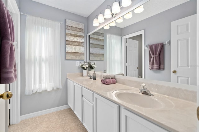 460 Tess Ct, Orlando, FL 32824 - bathroom with baseboards, double vanity, and tile patterned floors