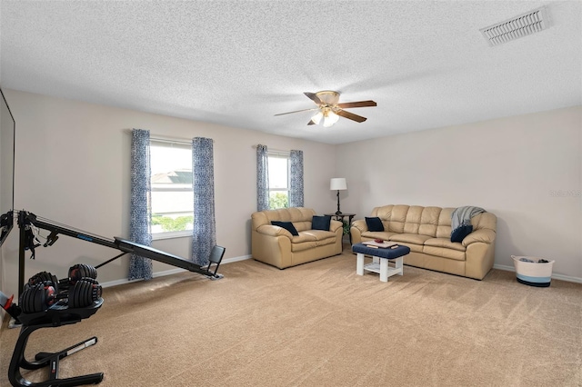 460 Tess Ct, Orlando, FL 32824 - living area with light carpet, ceiling fan, baseboards, and a textured ceiling