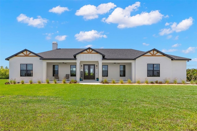 modern inspired farmhouse featuring a ceiling fan, french doors, a front yard, and a chimney