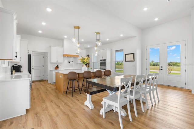 dining area featuring light wood-style flooring and recessed lighting
