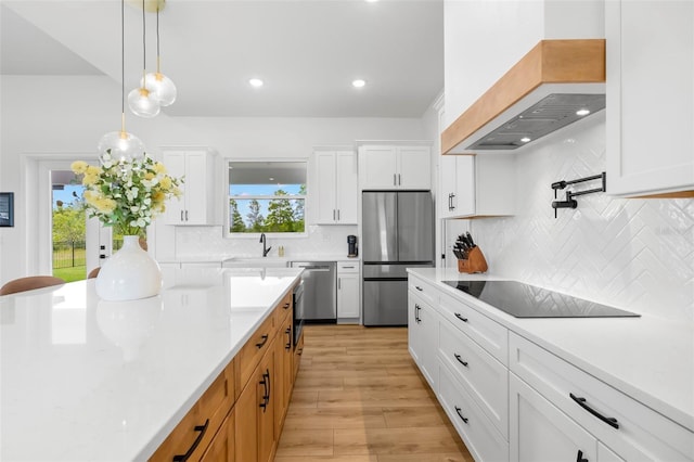kitchen with stainless steel appliances, custom exhaust hood, a sink, white cabinets, and recessed lighting