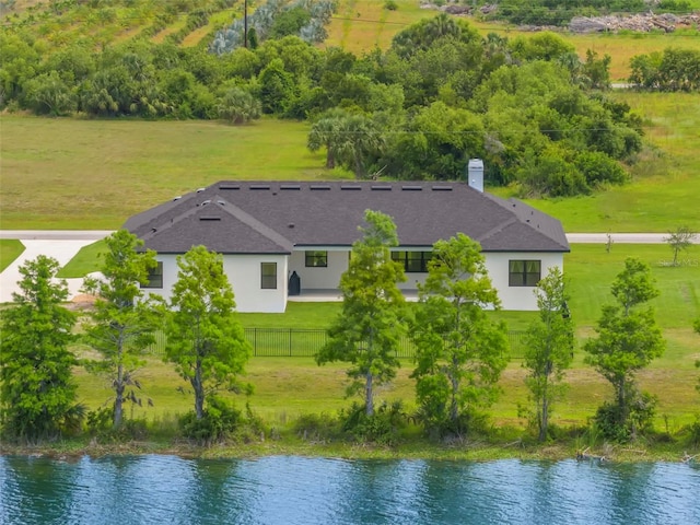 aerial view of property and surrounding area featuring a nearby body of water