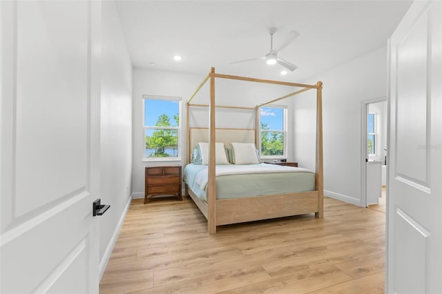 bedroom featuring light wood-type flooring, baseboards, recessed lighting, and a ceiling fan