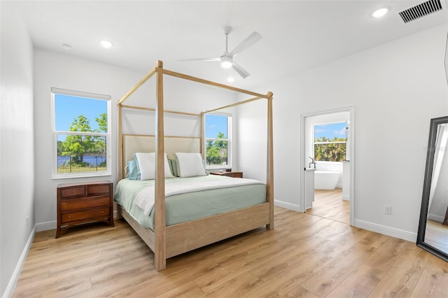 bedroom featuring light wood finished floors, baseboards, recessed lighting, ensuite bathroom, and a ceiling fan