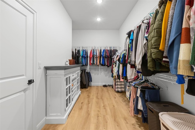 walk in closet with light wood-type flooring