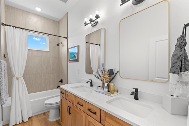 bathroom featuring shower / bath combo, double vanity, toilet, and wood finished floors