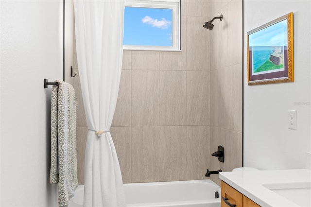 bathroom featuring shower / bath combo with shower curtain and vanity