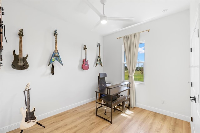 office area with ceiling fan, light wood-style flooring, and baseboards