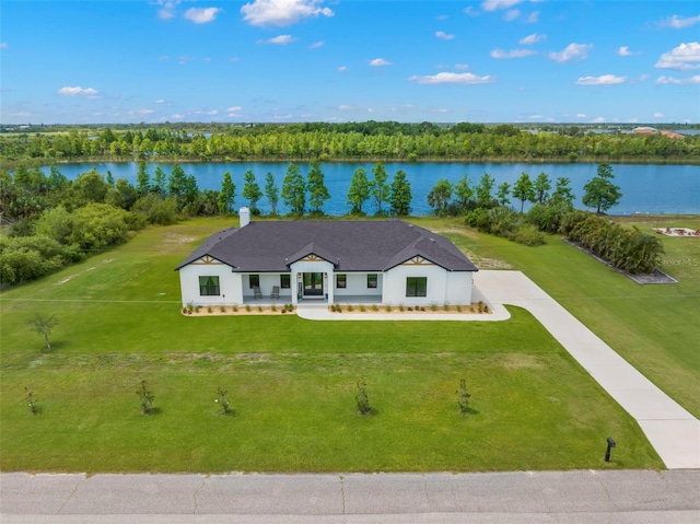 aerial view of property and surrounding area with a nearby body of water
