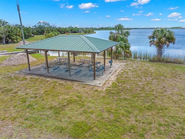 view of property's community with a gazebo, a yard, and a water view