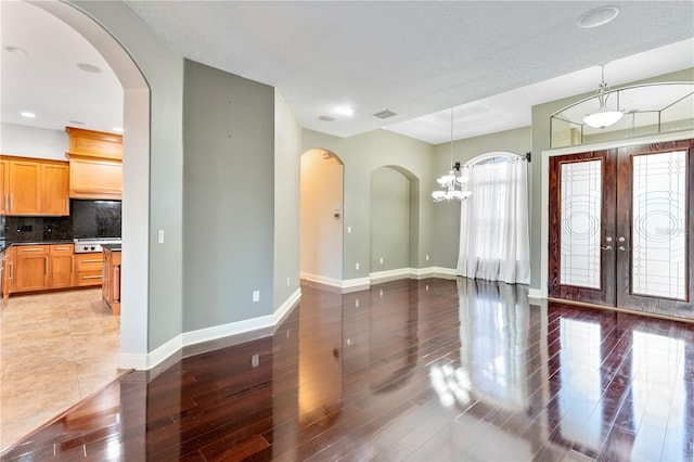 15104 Azra Dr, Odessa, FL 33556 - entryway with wood finished floors, baseboards, french doors, arched walkways, and recessed lighting