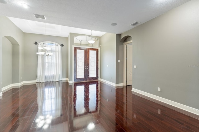 15104 Azra Dr, Odessa, FL 33556 - entrance foyer with arched walkways, wood finished floors, baseboards, french doors, and a chandelier