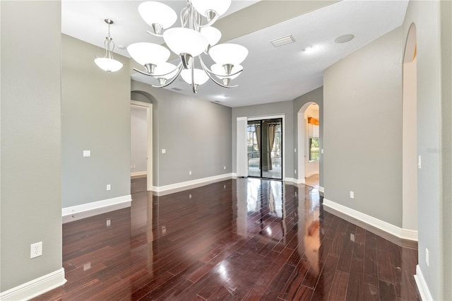 15104 Azra Dr, Odessa, FL 33556 - spare room featuring arched walkways, a chandelier, wood finished floors, and baseboards