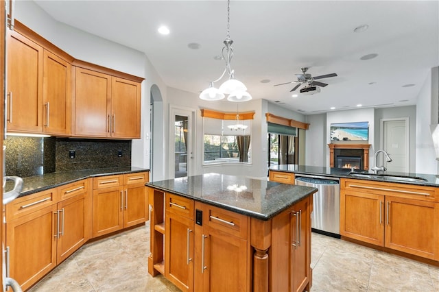 15104 Azra Dr, Odessa, FL 33556 - kitchen featuring dishwasher, a sink, a center island, a lit fireplace, and brown cabinetry