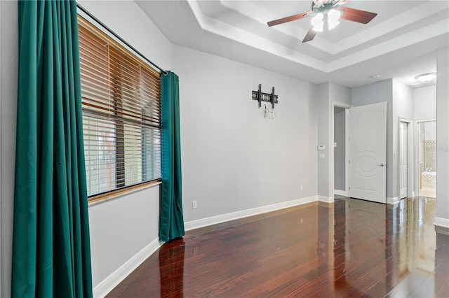 15104 Azra Dr, Odessa, FL 33556 - spare room featuring a ceiling fan, a raised ceiling, wood finished floors, and baseboards