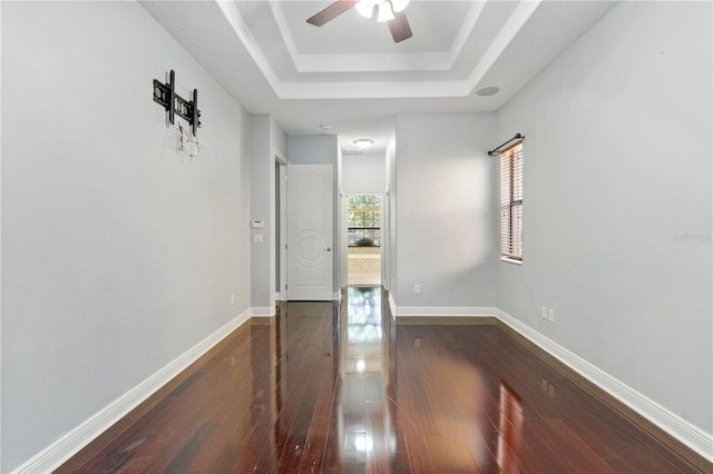 15104 Azra Dr, Odessa, FL 33556 - spare room featuring dark wood finished floors, a raised ceiling, ceiling fan, and baseboards