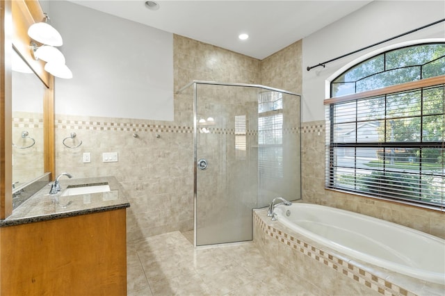 15104 Azra Dr, Odessa, FL 33556 - bathroom featuring tile walls, healthy amount of natural light, tiled shower, and a bath