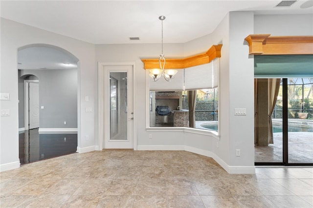 15104 Azra Dr, Odessa, FL 33556 - unfurnished living room with baseboards, arched walkways, and a chandelier