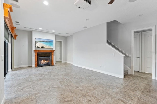 15104 Azra Dr, Odessa, FL 33556 - unfurnished living room featuring a glass covered fireplace, stairs, recessed lighting, and baseboards