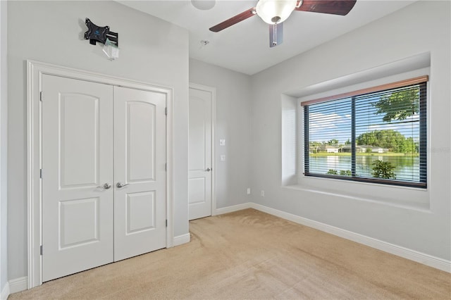 15104 Azra Dr, Odessa, FL 33556 - unfurnished bedroom featuring light carpet, baseboards, a closet, and ceiling fan